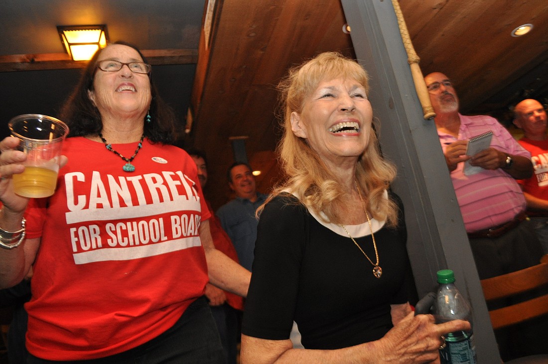 Mary Cantrell, right, smiles as her campaign volunteers announce she has taken the lead in the election. Nolan Middle School teacher Margi Nanney cheers from behind.