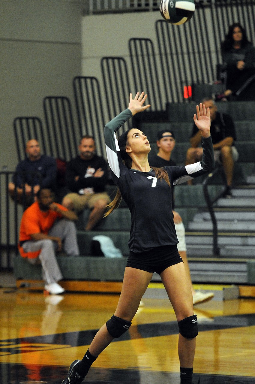 Junior Cree Lotterer serves the ball for the Lady Mustangs in the second set.