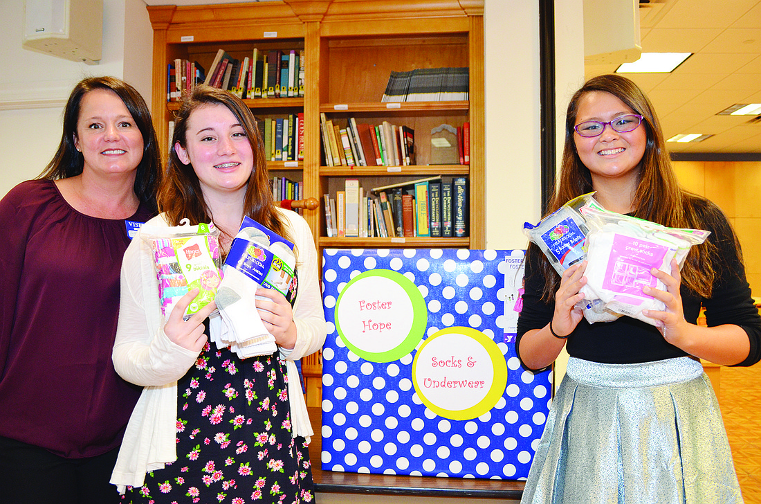 Katherine Leaver, Hayes Leaver and Lauren Yenari have set up boxes at various locations to collect socks and underwear for foster children. Photos by Amanda Morales