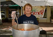 Food Bank of Manatee volunteer Evelyn Parcels serves up a seafood soup.