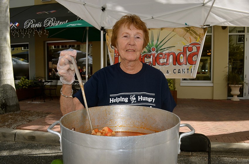 Food Bank of Manatee volunteer Evelyn Parcels serves up a seafood soup.