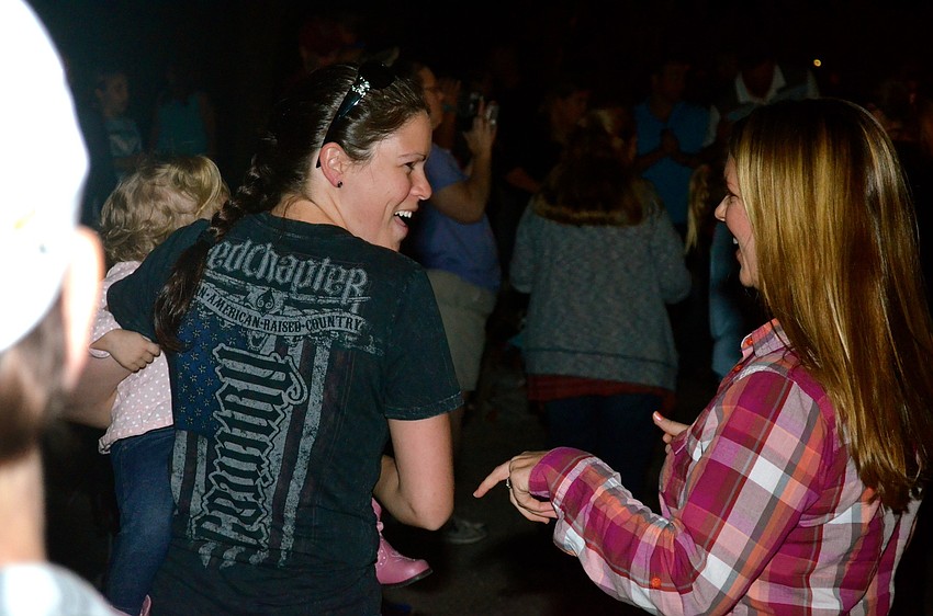 Heather Hall and Valerie Jackson dance to the music.