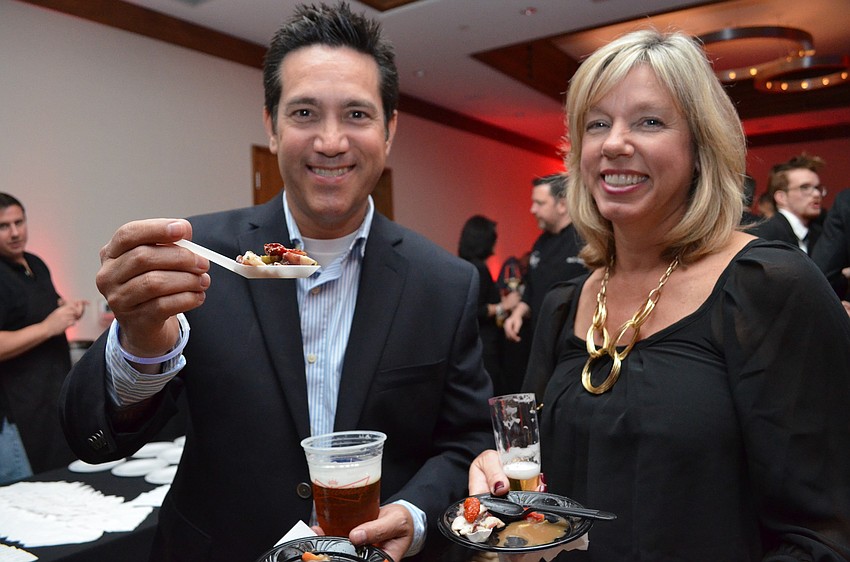 Rob and Jodi Caragiullo enjoy the octopus appetizer from The Crab+Fin at the Art of Food Festival.