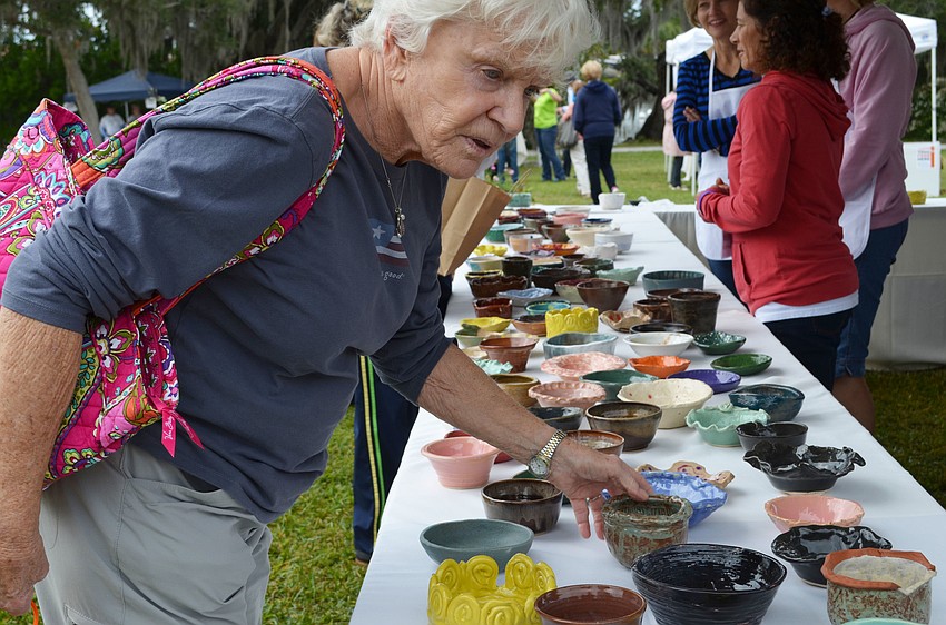 Barb Thomason decides which bowl to take home from Bowls of Hope.