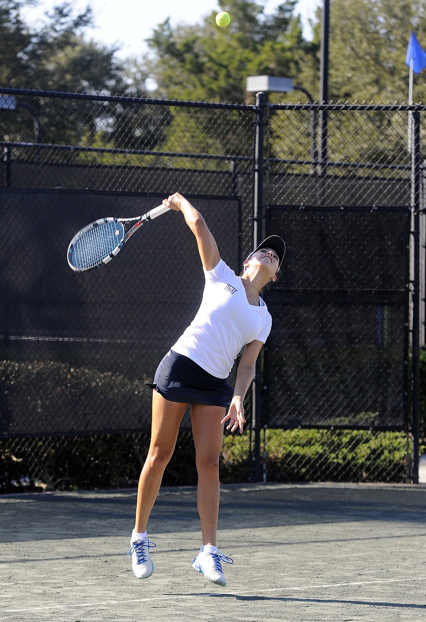 The University of North Floridaâ€™s Mariella Calderon serves the ball during doubles competition Nov. 7.