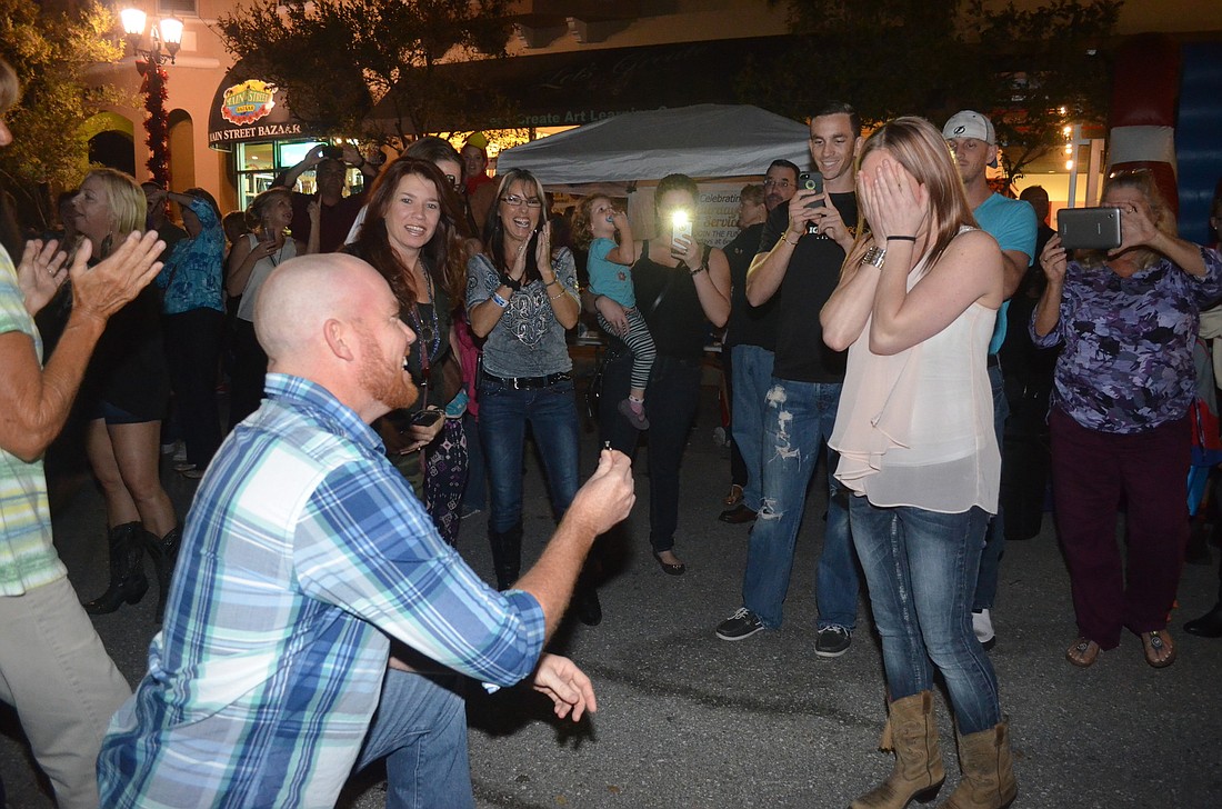 Phill Phelan proposes to Kailee Burgess after a flash mob dance routine to Brad PaisleyÃ¢â‚¬â„¢s "Wrapped Around." Photos by Amanda Sebastiano
