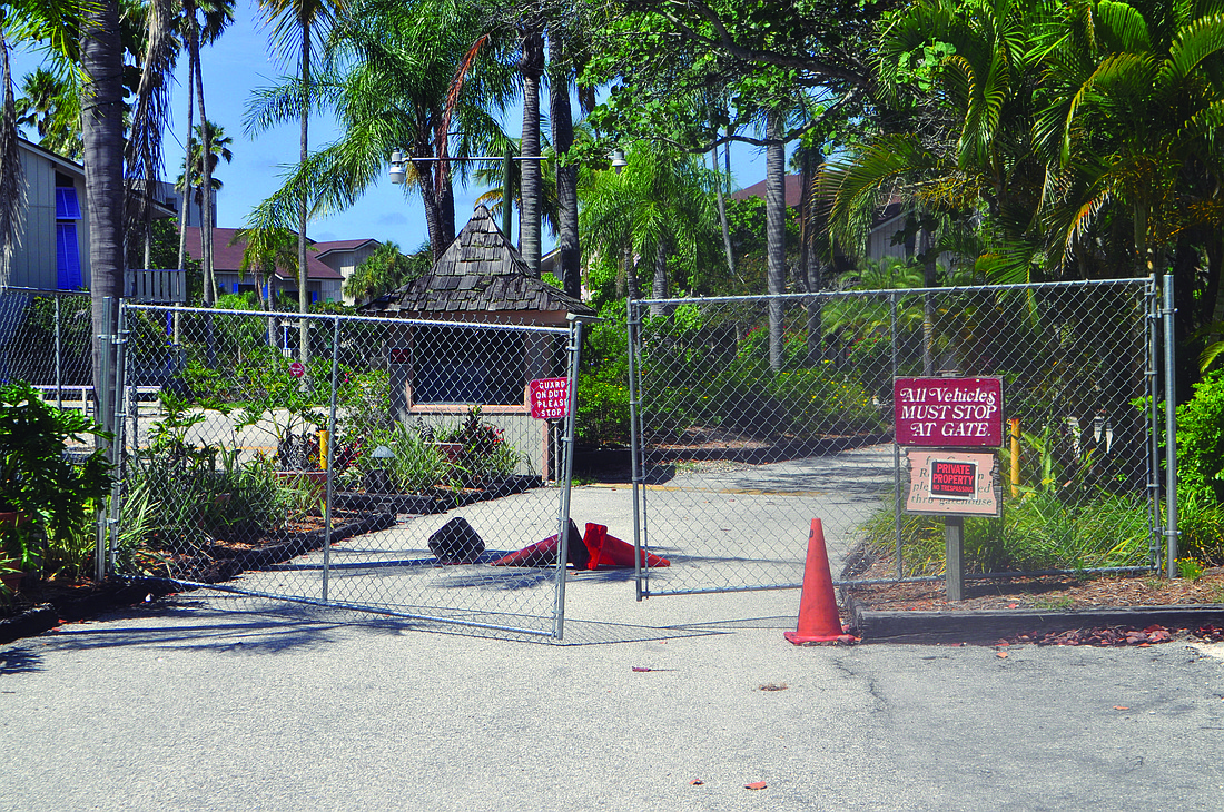 A chainlink fence surrounds the Colony Beach & Tennis Resort to deter trespassers. File photo