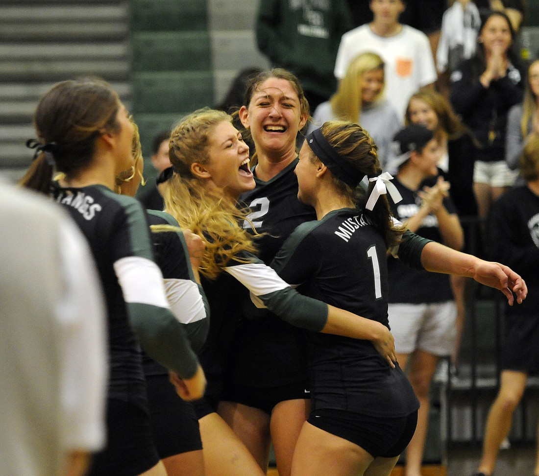 Layne Thompson, Nicole Grant and Kelley Ainsworth celebrate following their 3-0 victory over Fort Myers in the Class 7A-Region 3 finals Nov. 8. Photos by Jen Blanco