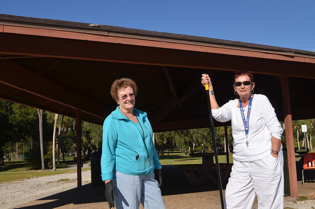 Linda Holland and Linda Jacob work to clean up the pavilion at Gillespie Park in advance of an event Wednesday.