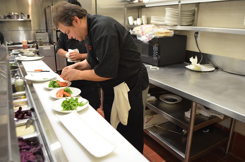 Executive Chef Andrea Bozzolo creates an arugula salad.