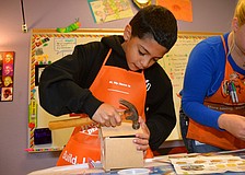Nathan Garcia crafts his first birdhouse.