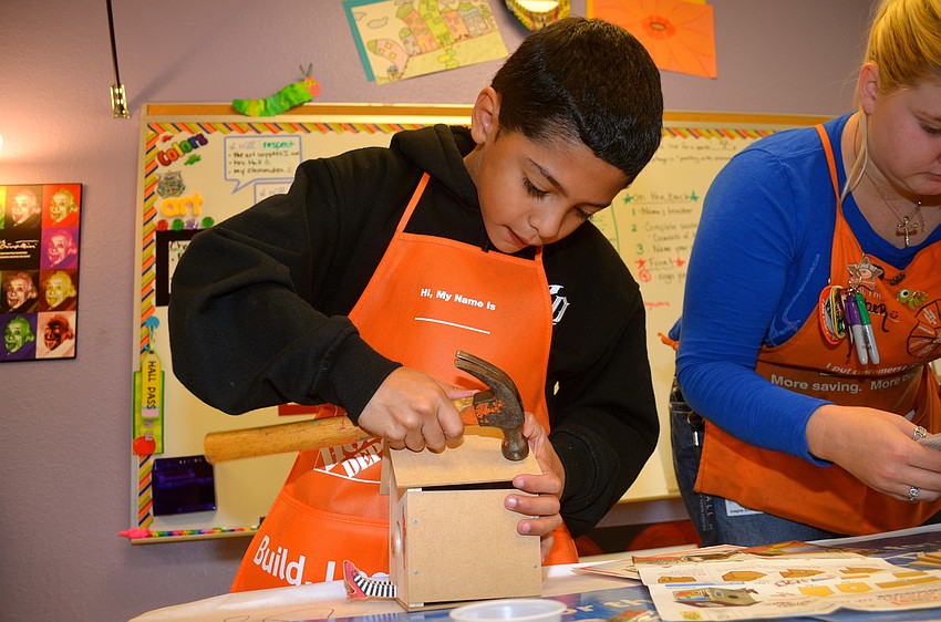 Nathan Garcia crafts his first birdhouse.