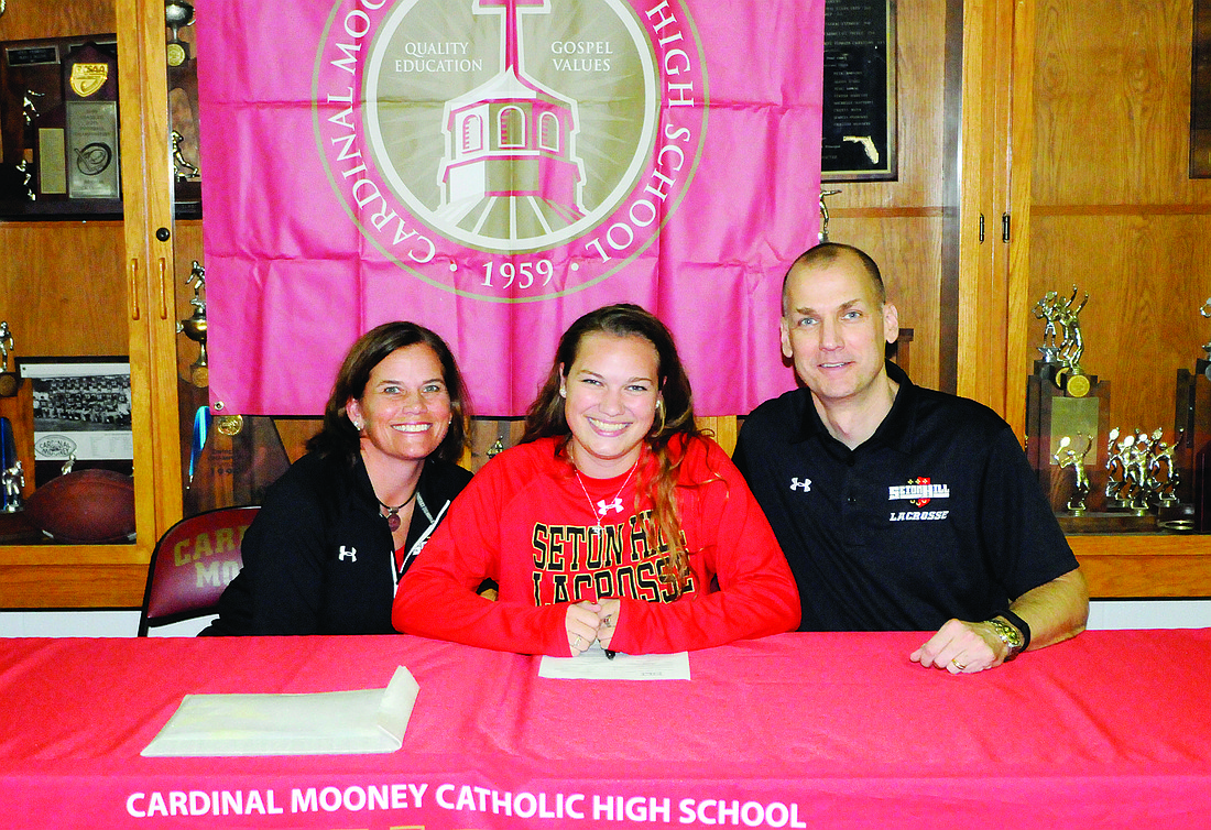 Cardinal Mooney senior defender Carolina Krupa, pictured with her parents, Paula and Ron, signed a national letter of intent Nov. 17 to play collegiate lacrosse.