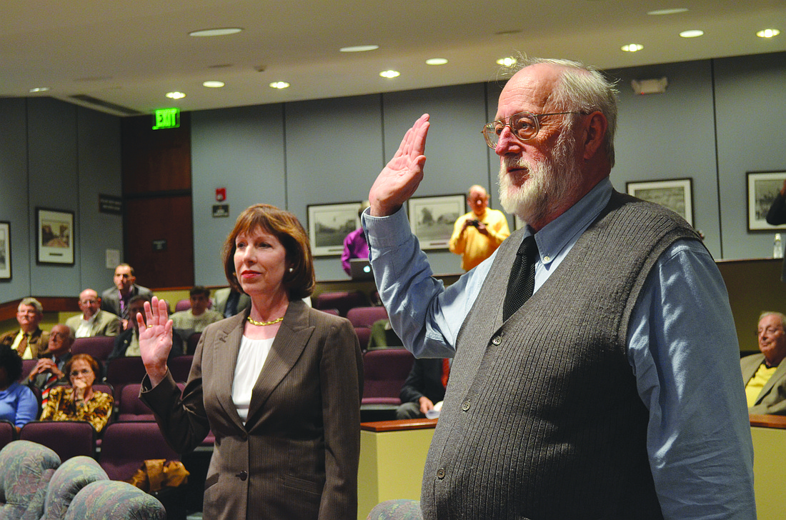 The city auditor and clerk swears in Eileen Normile and Stan Zimmerman Wednesday. Photo by David Conway