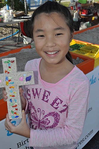 Audrey Lui crafts a cross at a previous Mixon Harvest Festival.