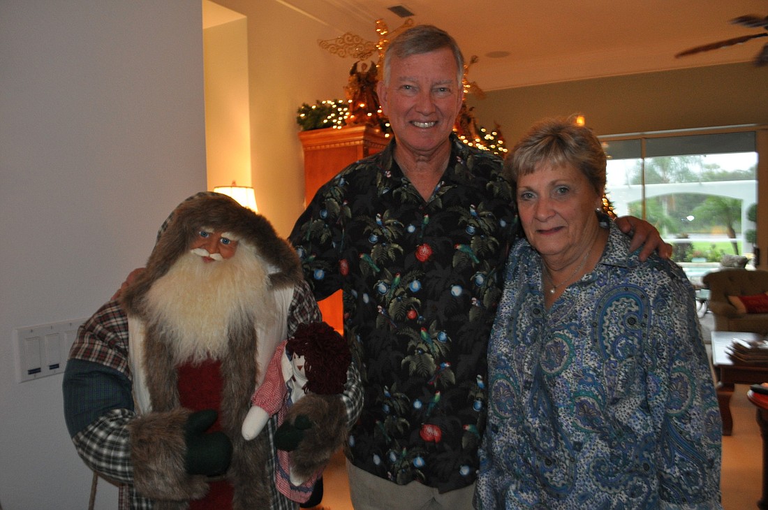 Harry and Mary Jo Steltman stand by the first life-size Santa decoration that sits in the entryway to their home.