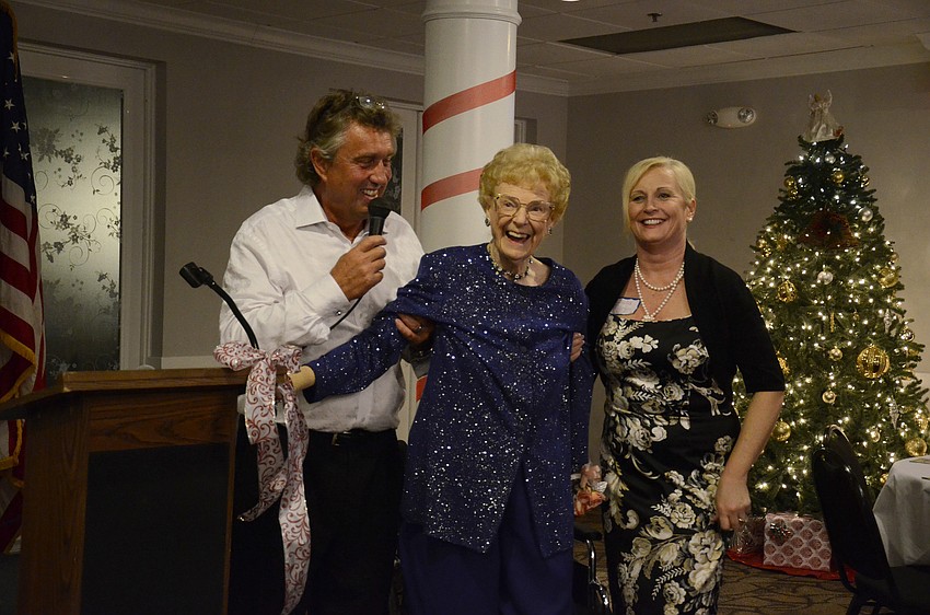 Norma Martin, center, stands with Rod Thomas, left, and Laura Martin, right, and thanks a 100-person crowd for attending her party Thursday night.