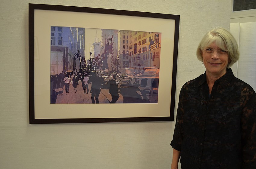 Kris Parins in front of her watercolor entitled â€œEmpire State.â€