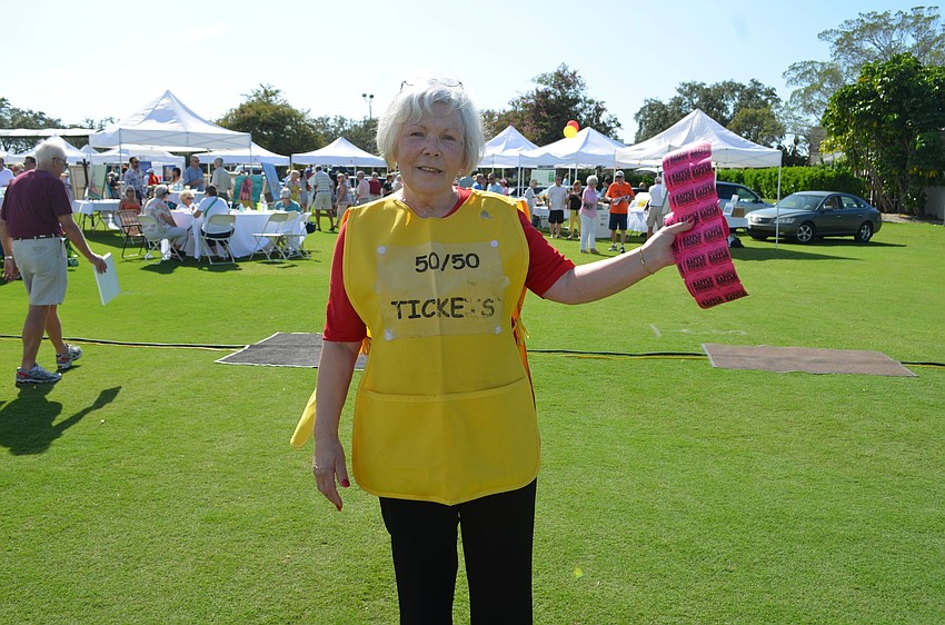 Norah Browne sells 50/50 raffle tickets, which raised $3,500.