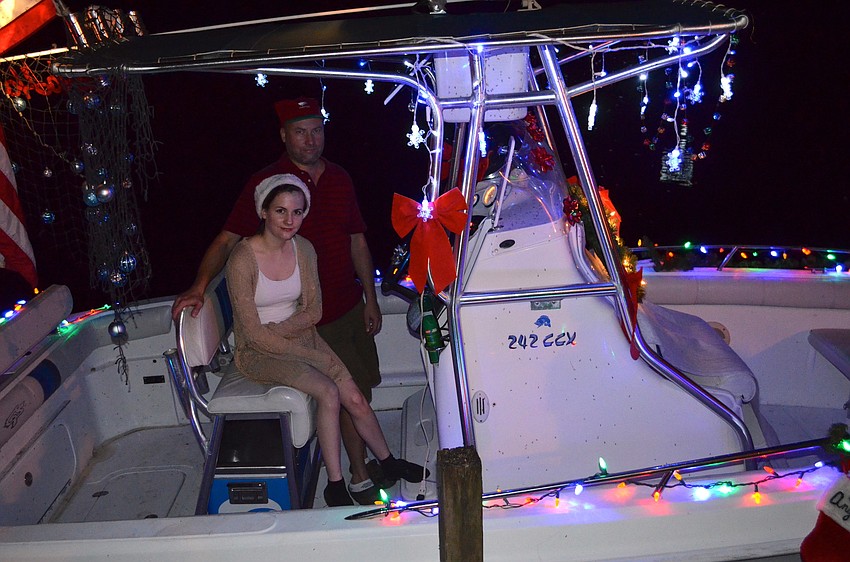 Leah Mehtala and her father, Ossi, show off their boat.