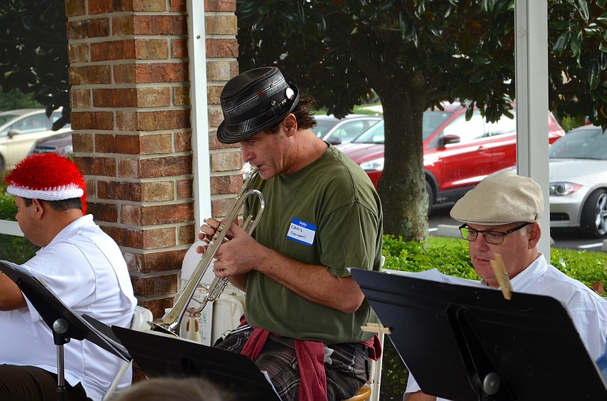 Chris Verney warms up the trumpet before the performance.