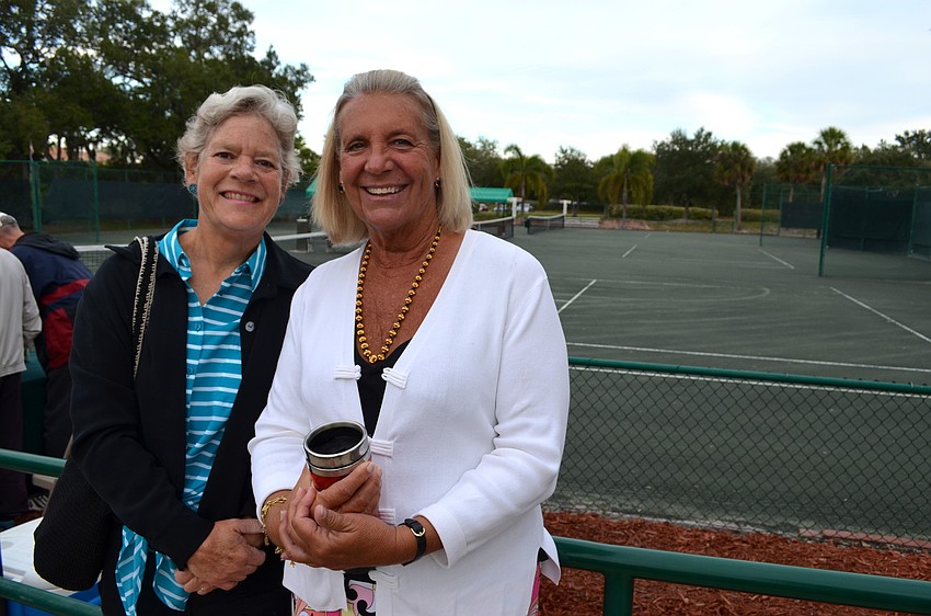 Helen Turner and Holly Parker enjoy the tennis match from the sidelines.