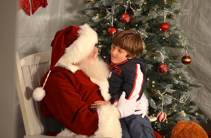 Santa listens to Carter Ebling's Christmas list.