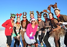 Erica Lawson and her bachelorette party reindeers prepare for the Sandy Claws Beach Run.