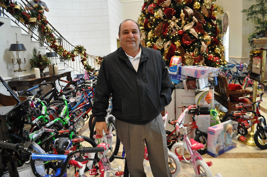 Lakewood Ranch Golf and Country Club Manager Wayne Piazza stands among its Toys for Tots donations. The club collected more than $15,000 worth of toys this year. Photo by Pam Eubanks