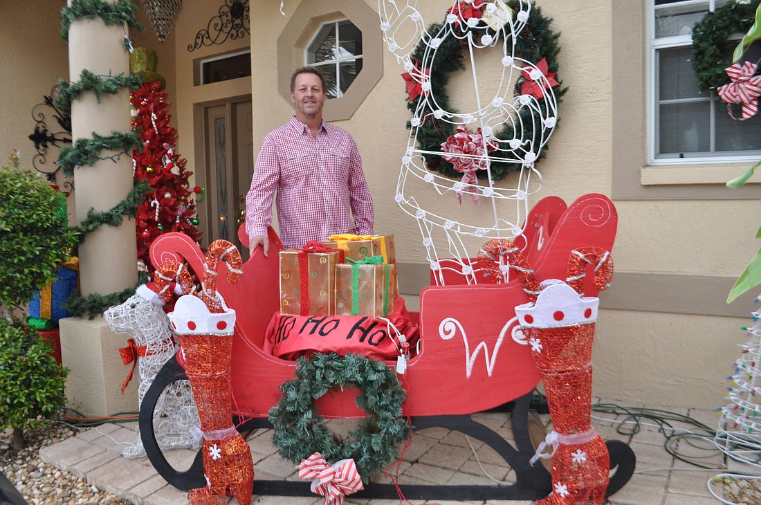 Joe Willis' display features a collapsible sleigh his college roommate made for him. It takes him a week to get his outside decorations just right. Photos by Pam Eubanks