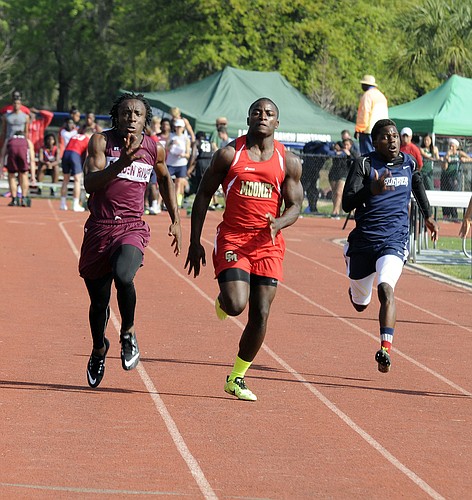 Braden River's Ahmad Dunbar, Cardinal MooneyÃ¢â‚¬â„¢s Demardre Patterson and ODA's Josh Lerner race to the finish line in the 100-meter dash at The Out-of-Door Academy Invite March 22.