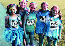 Runners make a colorful statement during the Run or Dye 5K at Nathan Benderson Park. Chloe and Christopher Camacho, Keira Jackson and Selah and Abby Swanson show off their new post-race colors.