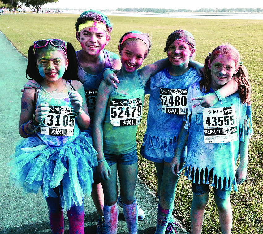 Runners make a colorful statement during the Run or Dye 5K at Nathan Benderson Park. Chloe and Christopher Camacho, Keira Jackson and Selah and Abby Swanson show off their new post-race colors.