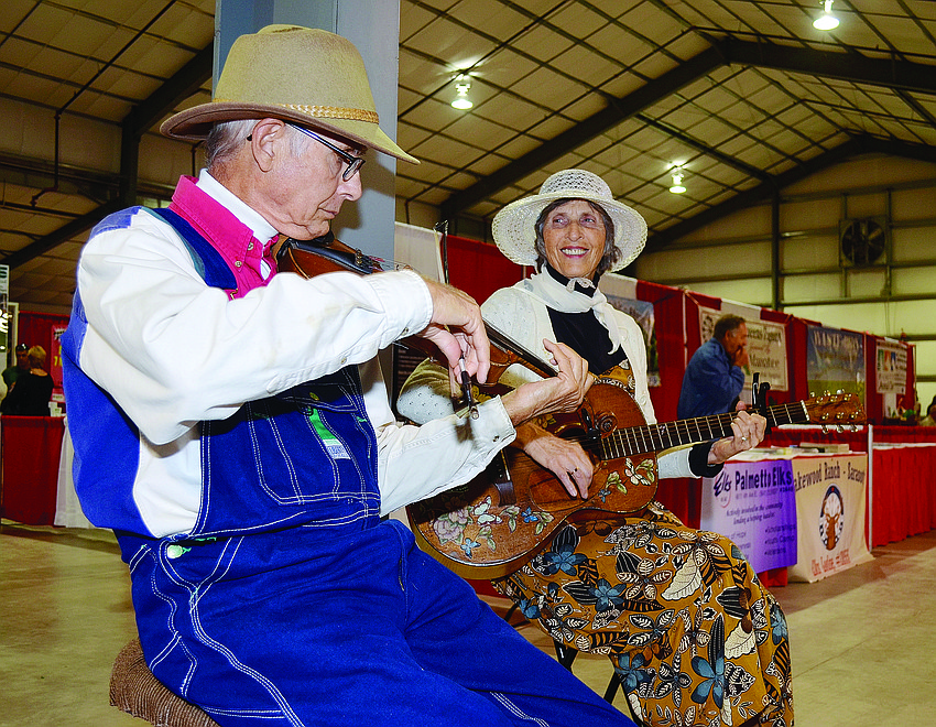 Ed and Geraldine Berbaum team up to play guitar and the fiddle for guests at the Manatee County Fair. 2