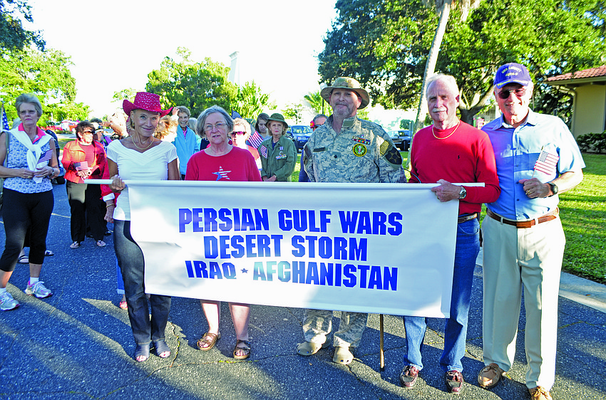 Sunny McGrath, Barbara Anne Manning, Craig Dropkin, Richard McGrath and Vietnam veteran Bob Hamel march in the inaugural Rotary Club of Longboat Key Veteranâ€™s Day Parade Nov. 11, on Bay Isles Road.