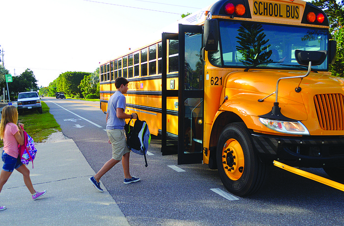 Ciarra Buff and Joseph Peery board the bus bound for Martha B. King Middle School on the first day of school Aug. 18.