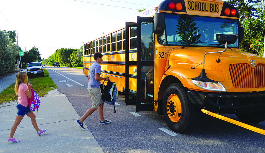 Ciarra Buff and Joseph Peery board the bus bound for Martha B. King Middle School on the first day of school Aug. 18.