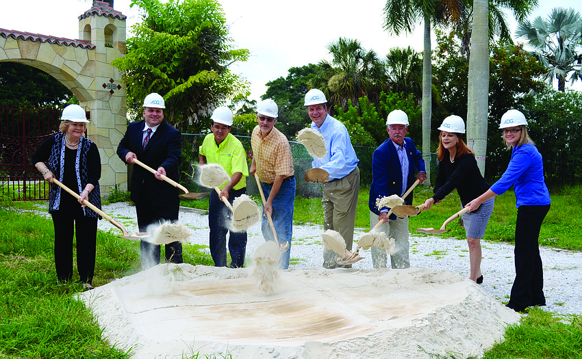 Lori Fountain, Peter Tuffo, Alcides Santiesteban, Eric Mauger, developer Jay Tallman, Mayor Jim Brown, Amy Drake and Angie Kimmich sport hardhats as they celebrate the groundbreaking of Aria condominium June 25.