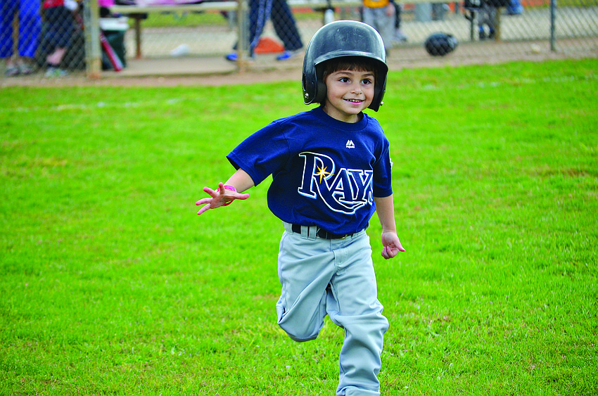 Dominic Mattera runs to first base at the 75th annual opening day of Sarasota Little League in May.