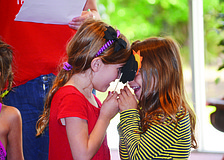 Liza Collier and Ana Yavitz act out the plague of darkness at The Gan at Temple Sinai's Passover Sensory Experience.