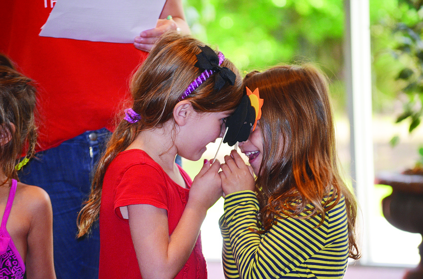 Liza Collier and Ana Yavitz act out the plague of darkness at The Gan at Temple Sinai's Passover Sensory Experience.