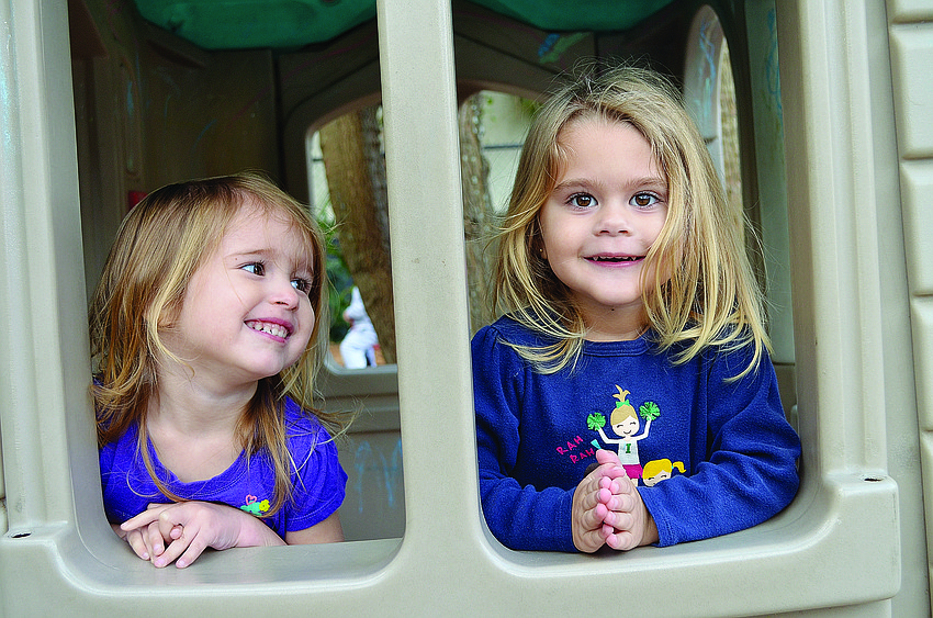 Lily Thiron and Ashlyn Shelson take a break from riding their tricycles at the Early Care Center of First United Methodist Church's annual St. Jude Trike-A-Thon.