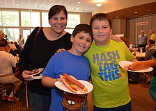 Renee Fletcher with her sons Jack and Max were excited to try hot dogs and dessert at the Jewish Food Festival.