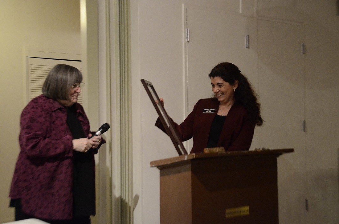 Kafi Benz presents Lourdes Ramirez with an award naming her the 2014 Citizen of the Year.