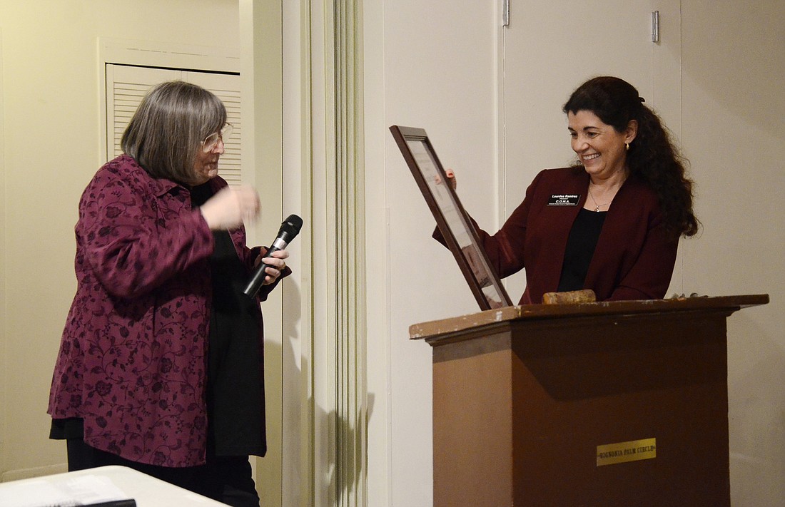 Kafi Benz, new board president, presents Lourdes Ramirez with CONA's 2014 Citizen of the Year award. Photo by Jessica Salmond
