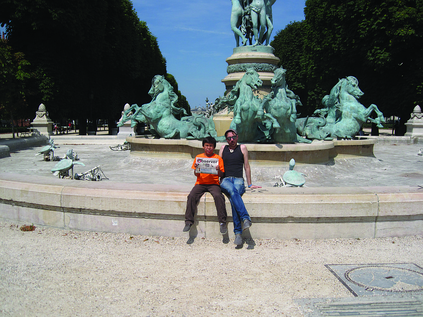 FRENCH CONNECTION. Patrick Enright visited his uncle, Frank Enright, this summer in Paris and caught up on their Observer news near the Eiffel Tower.