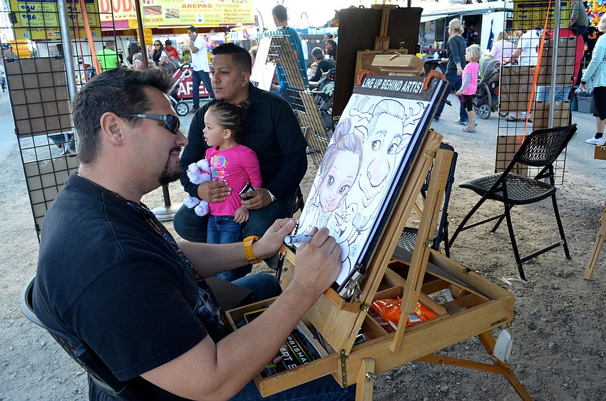 Tim Reed sketches Mario Castillo and his daughter, Avalynn.