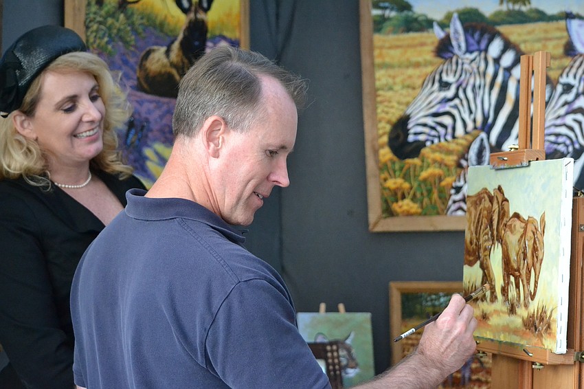Dena Baker watches Andy Taylor create a new piece to display for the Sarasota Fine Art Festival.