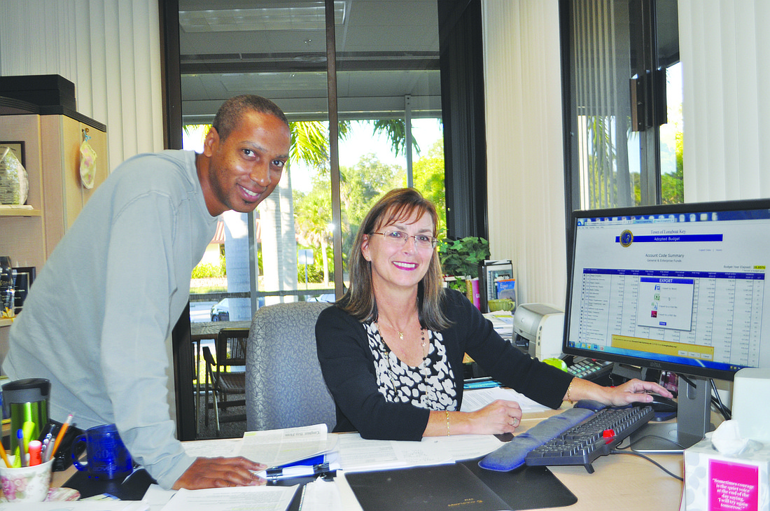 Information Technology specialist Barry Gaines and MIS Director Kathi Pletzke look at financial data using the town's new fiscal transparency tool. Photo by Robin Hartill