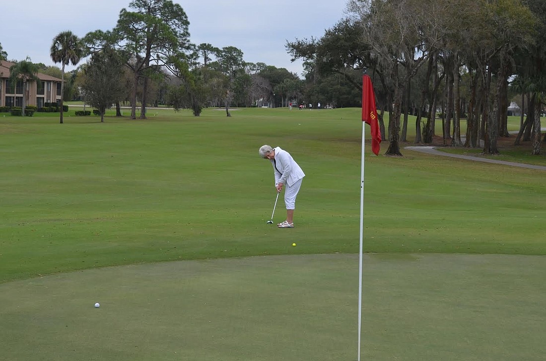 Shirley Kelley of Sarasota hits a putt that approaches the green Tuesday at The Palm-Aire Country Club Tuesday.
